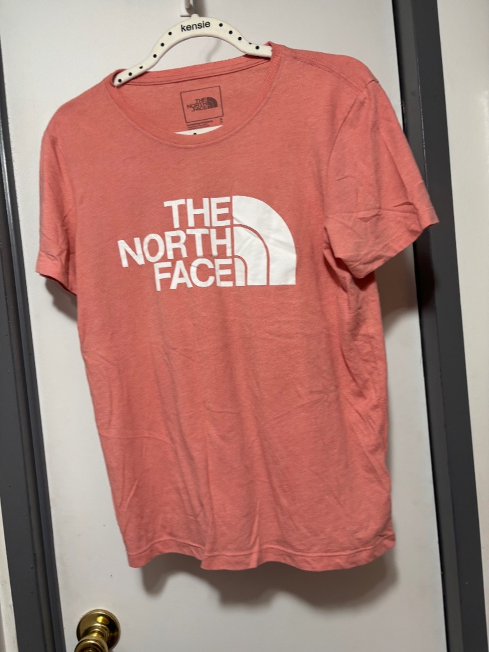 North face peach colored top